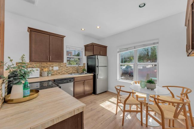 Kitchen with stainless steel appliances, healthy amount of natural light, recessed lighting, and light countertops | Image 10