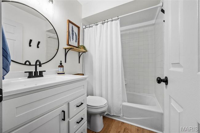 Full Guest Bathroom with vanity, LVP floors, and shower / tub combo with curtain | Image 17