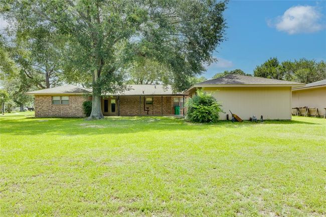 Large back yard has plenty of room for a trampoline , flower garden, and gym set | Image 23