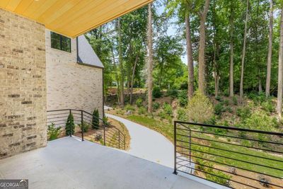 Front of Structure - Large covered front porch with a scenic wooded front view. Plenty of room for enjoying a cup of coffee in the mornings! | Image 2