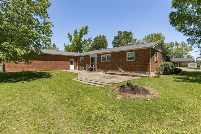 Back of house featuring entry steps, a patio area, brick siding, and a yard | Image 7