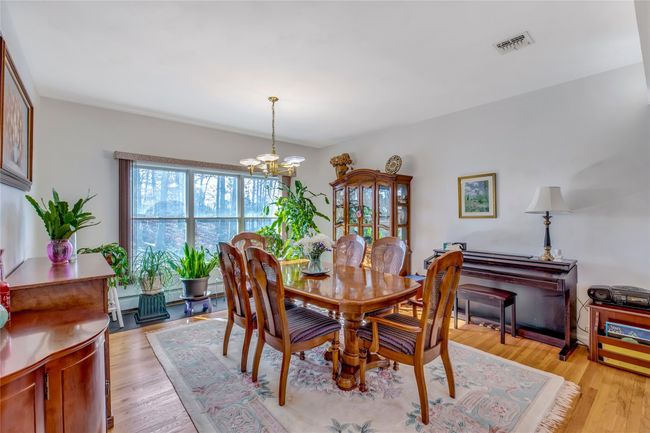 Dining space featuring a chandelier and light hardwood / wood-style floors | Image 7