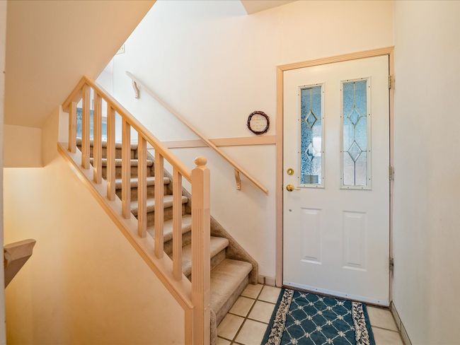 Entryway with light tile patterned floors and stairway | Image 24