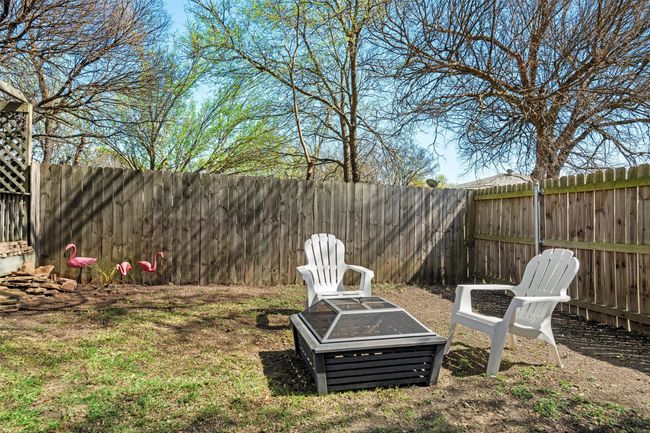 View of yard with a fenced backyard and a fire pit | Image 23