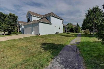 View of side of property with a garage and a yard | Image 3