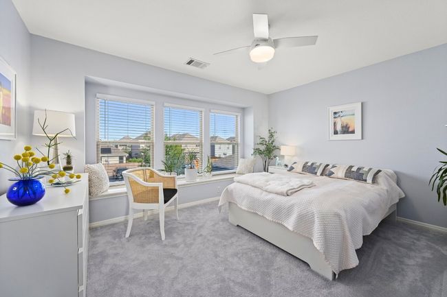 Carpeted bedroom featuring ceiling fan, baseboards, and visible vents | Image 30