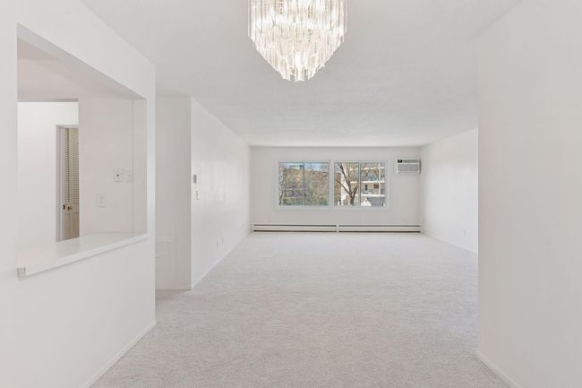 Living room and kitchen with new carpet and updated light fixtures | Image 12