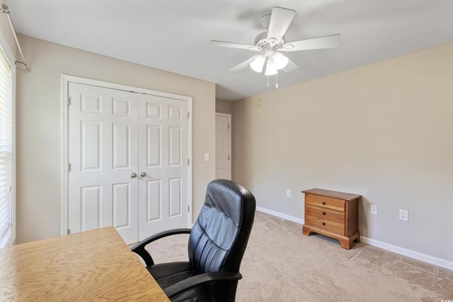 Office area featuring ceiling fan and light colored carpet | Image 26