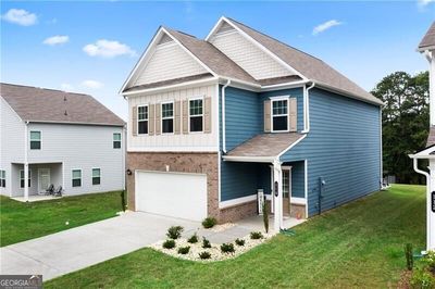 Craftsman inspired home featuring a garage and a front lawn | Image 2