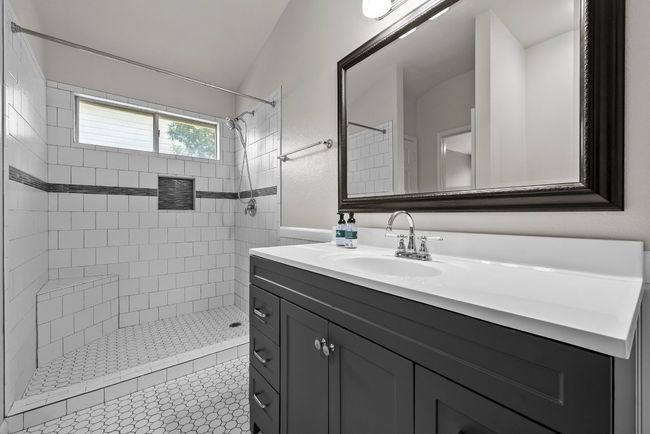 Bathroom featuring vanity and a tile shower | Image 14