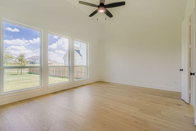 Empty room featuring light wood-type flooring and ceiling fan | Image 13