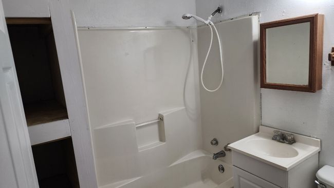 Full bath featuring shower / washtub combination, vanity, and toilet | Image 11