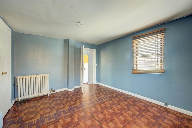 Empty room with radiator heating unit and baseboards | Image 33