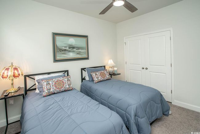Carpeted bedroom featuring baseboards, a closet, and ceiling fan | Image 13