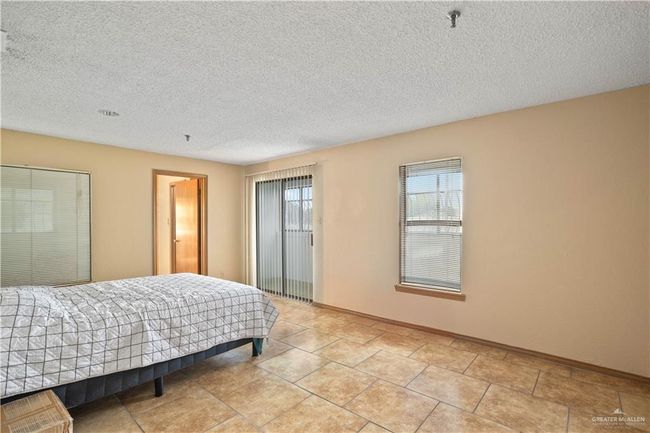 Bedroom with a textured ceiling | Image 13