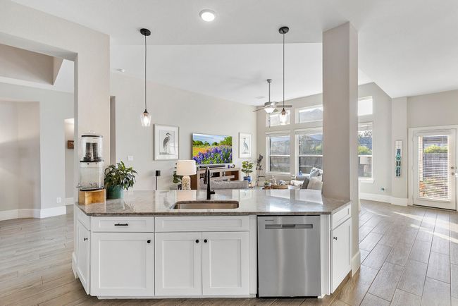 This photo highlights the bright, open view from the kitchen island, showcasing spacious design and modern finishes throughout. | Image 25
