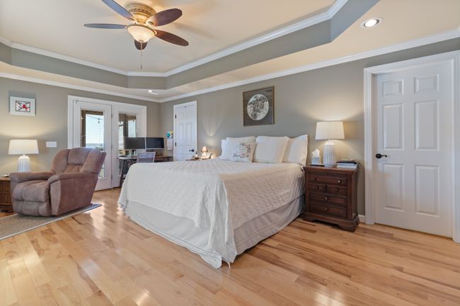 Spacious Master Bedroom boasts Tray Ceiling & Beautiful Hardwood Floors. Single door leads to Master Bath while Patio Doors lead to Private Screened-In Porch overlooking the LAKE! | Image 23