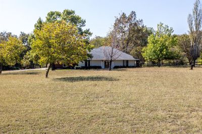 Home sets back from road on rolling acreage | Image 2