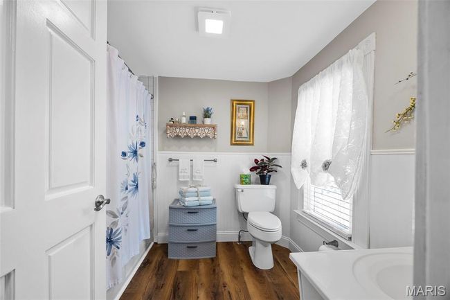 Bathroom featuring vanity, wood finished floors, and a shower with curtain | Image 21