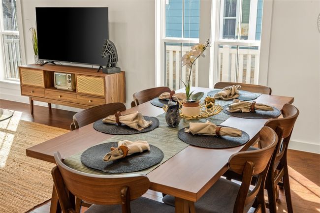 Dining space with wood finished floors and baseboards | Image 34