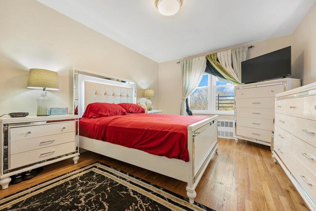Bedroom with radiator heating unit and hardwood / wood-style flooring | Image 6