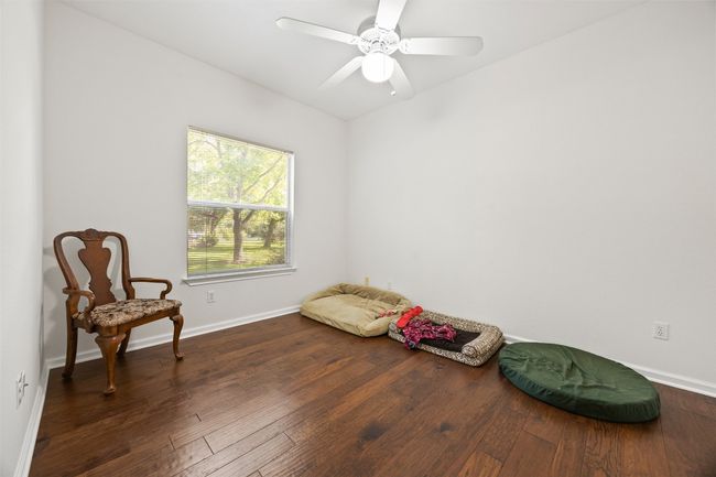 Living area with hardwood / wood-style flooring and a ceiling fan | Image 22