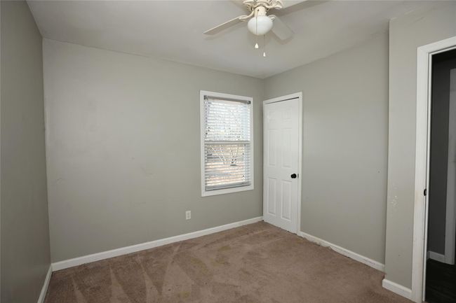 Unfurnished bedroom featuring ceiling fan, carpet floors, and a closet | Image 21