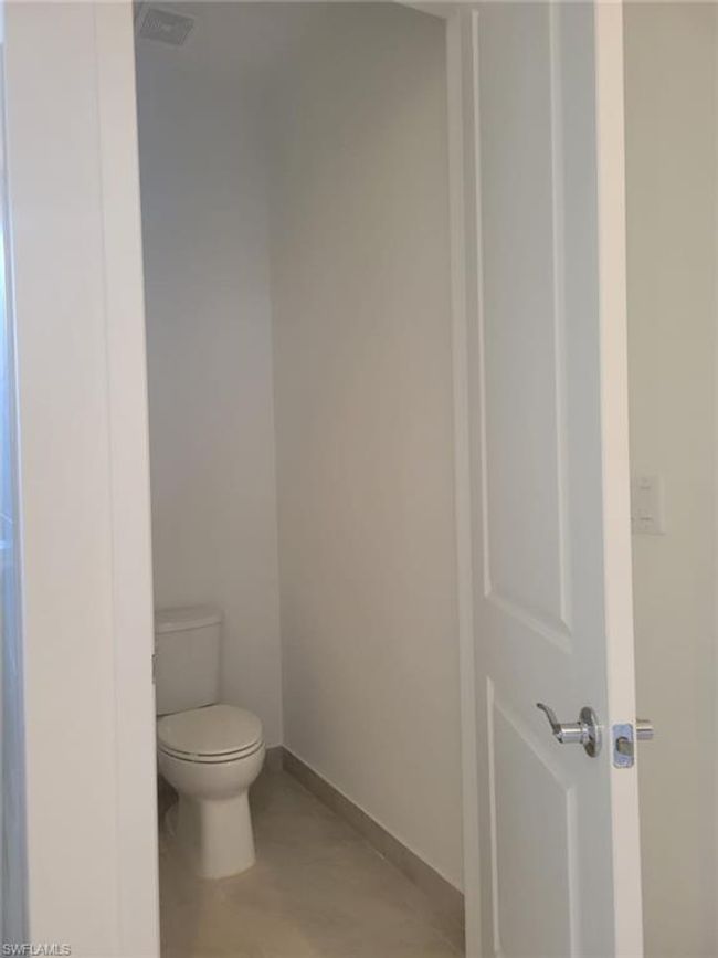 Bathroom featuring toilet and baseboards | Image 14
