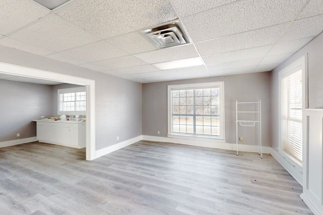 Unfurnished room with a paneled ceiling and a healthy amount of sunlight | Image 10