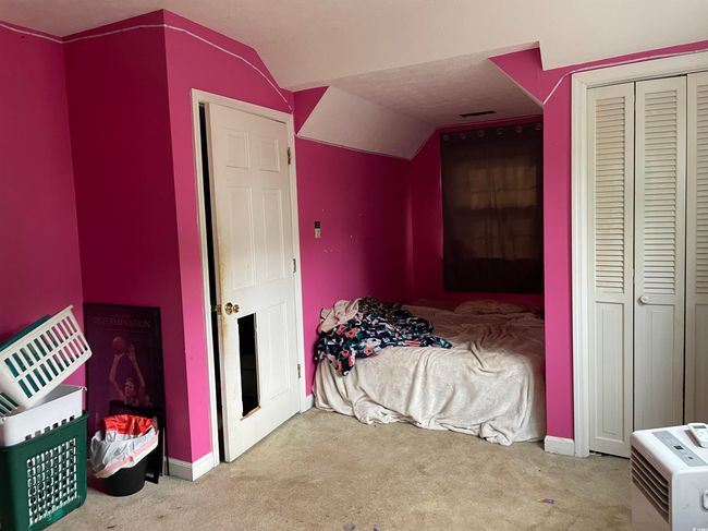 Bedroom featuring vaulted ceiling, carpet floors, and a closet | Image 26