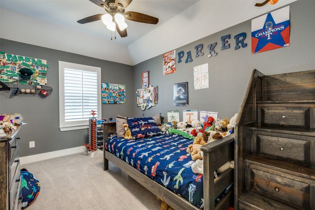 Carpeted bedroom with a ceiling fan and baseboards | Image 12