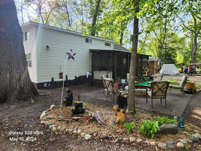 Patio area surrounding firepit, pretty landscaping and great home-away-from-home. | Image 22