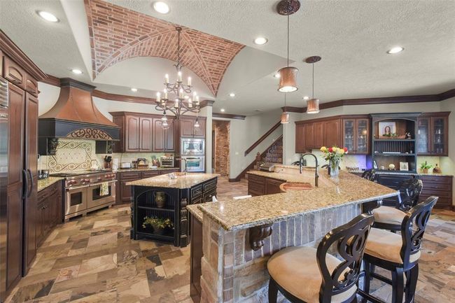 The perfectly appointed chef’s kitchen features brick groin ceiling | Image 15