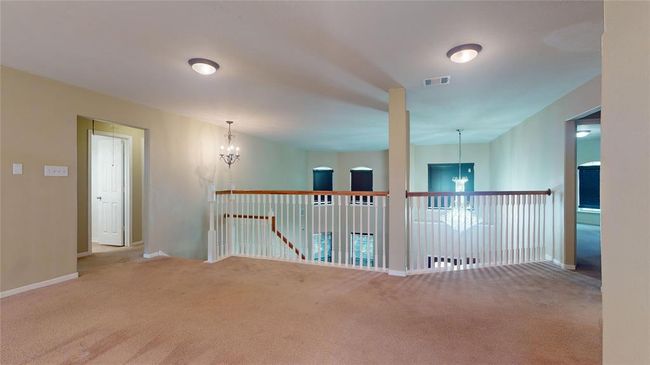 Expansive upstairs loft perfect for a cozy retreat or versatile home office, featuring elegant lighting and open views. | Image 30