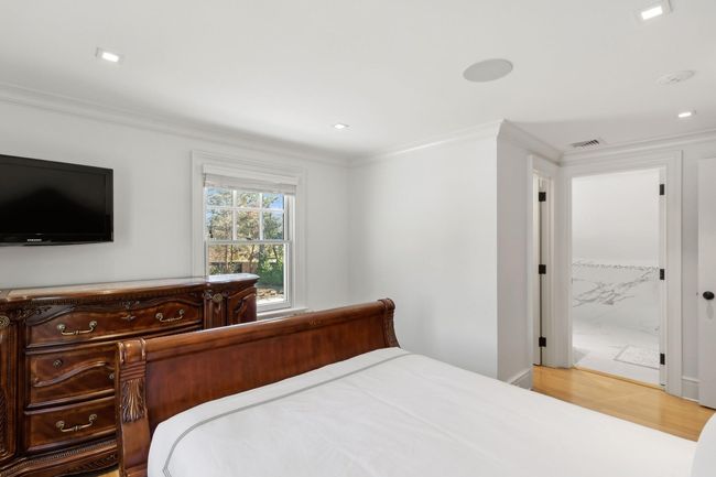 Bedroom featuring hardwood / wood-style flooring, ensuite bath, and crown molding | Image 37
