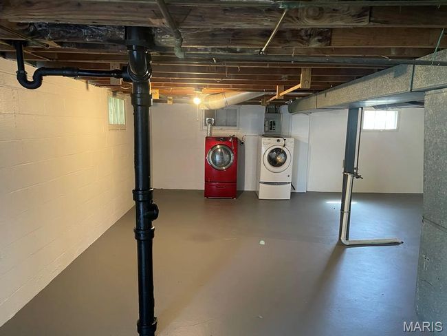 Basement featuring electric panel and washer and dryer | Image 25