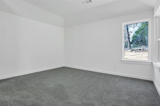 Unfurnished room featuring dark colored carpet and baseboards | Image 7