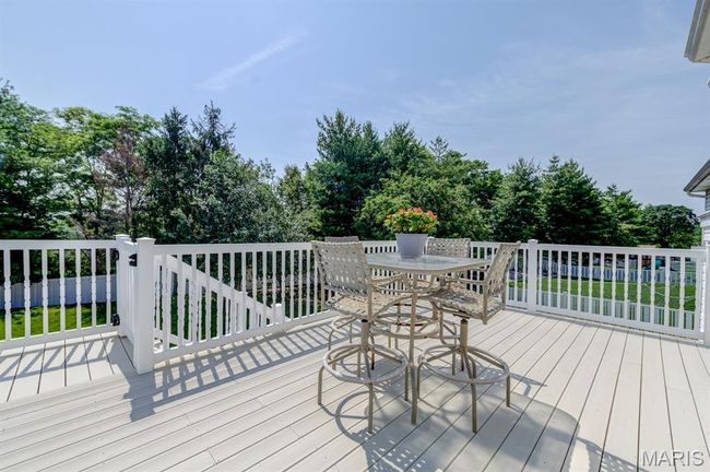 The deck is another generously proportioned amenity of this home. Walk through the gate to the back yard. | Image 15