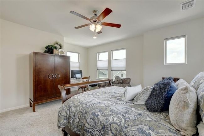 Bedroom featuring light carpet, baseboards, and ceiling fan | Image 19