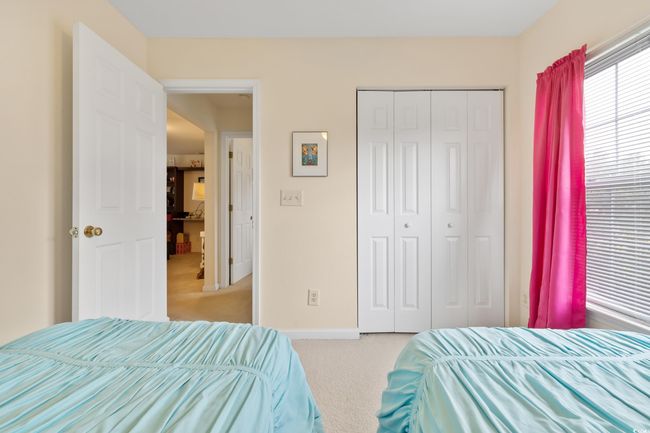 Bedroom with carpet flooring, a closet, and baseboards | Image 29