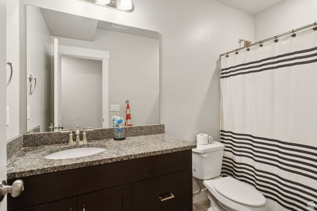 Bathroom with vanity and a shower with shower curtain | Image 37