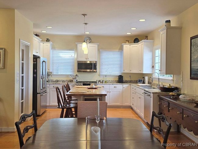 Kitchen with white cabinetry, appliances with stainless steel finishes, and a sink | Image 20