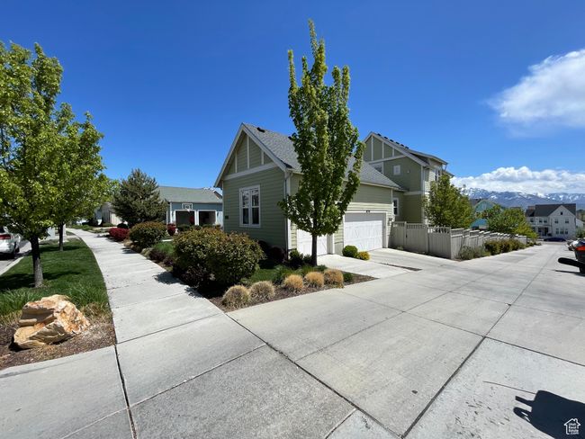 View of home's exterior with fence, driveway, and a residential view | Image 61