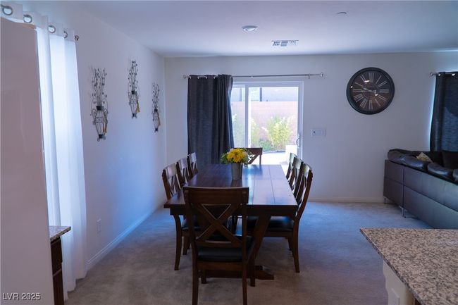 Dining area featuring light carpet, baseboards, and visible vents | Image 25