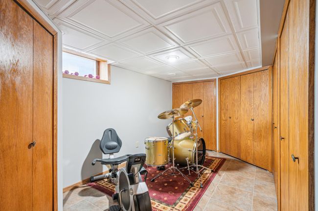 Basement flex space with ample storage options. | Image 34
