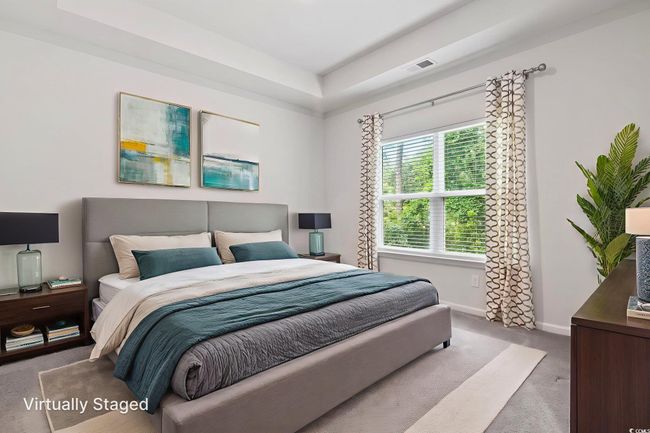 Bedroom with carpet flooring and a raised ceiling | Image 5