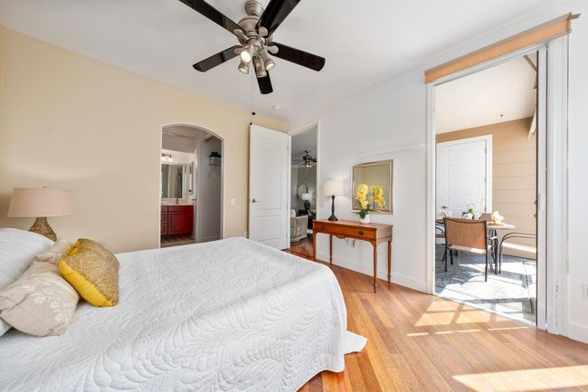 Primary bedroom has a door to the lanai, ocean views, and dressing room accesses to the primary bath. | Image 19