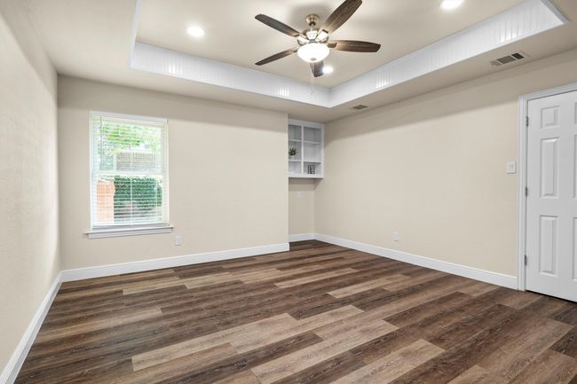 Another secondary bedroom has built in shelves. | Image 26