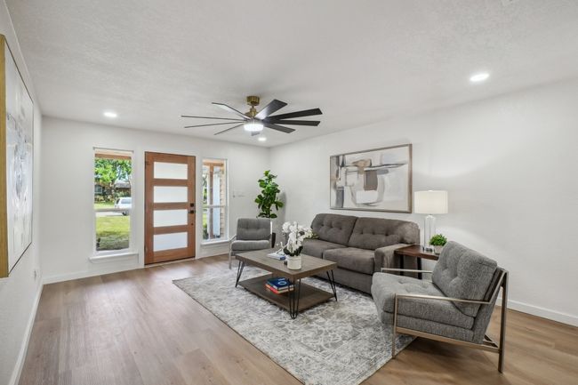 Living area with baseboards, a ceiling fan, recessed lighting, and wood finished floors | Image 5