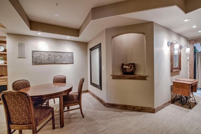 Head to the lower level to check out another warm and cozy gathering space. Built-in wet bar and space for games! | Image 35
